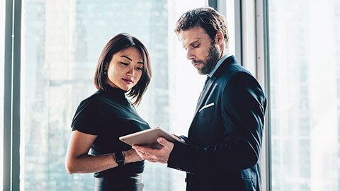 2 colleagues consulting legislation on a tablet device