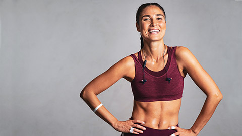 A smiling female trainer looking toward the camera after a workout