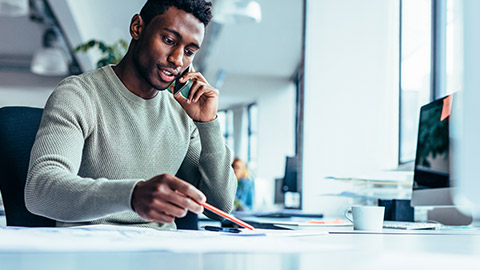 Fitness supervisor sitting at a desk checking over information to be distributed to employees