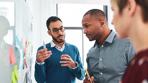 A business professional explaining information to his coworker