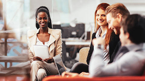 A diverse group of business colleagues in a relaxed office environment