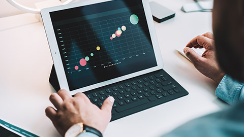 A financial officer interpreting a scatter plot on their tablet