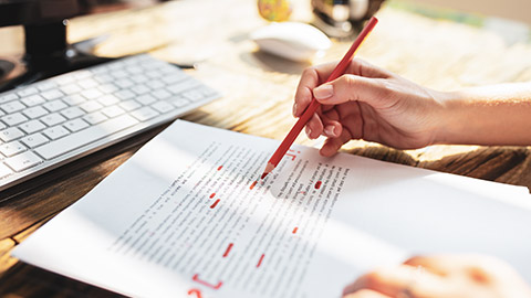 Close view of an editor marking up a manuscript