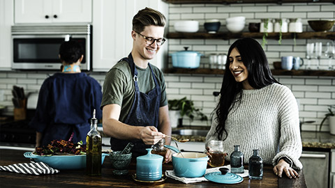 a couple of people cooking