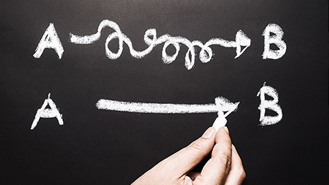 a hand writing on a blackboard