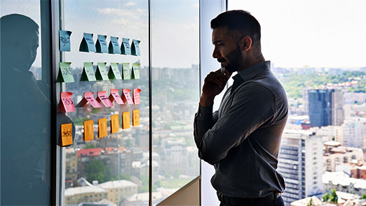 a professional looking over all options on a whiteboard