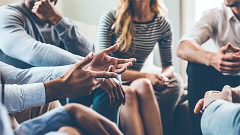 A group feedback session, held in a meeting room toward the end of a project