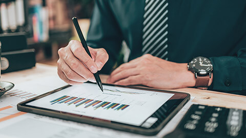 A close view of an accountant checking the numbers on a tablet device