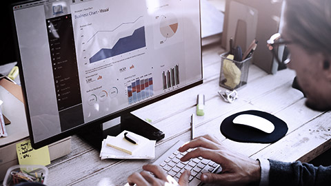 Man working on data dashboard on computer