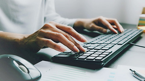 A close view of a person typing on a keyboard