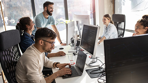 Group of designers programmers working on a new project at the office.