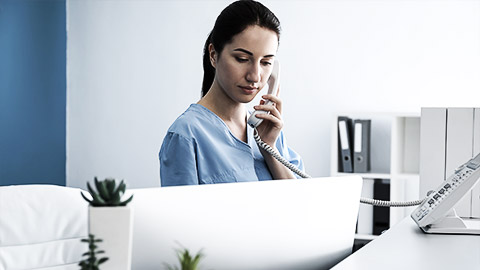 A vet assistant talking on the phone