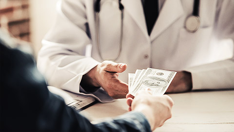 A veterinarian or receptionist recieving cash