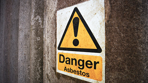 A close view of a sign warning of asbestos