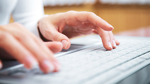 A close view of a person typing on a keyboard