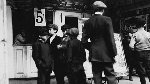 An old image of people outside a movie theatre