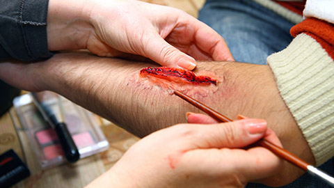 A makeup artist working on a movie set