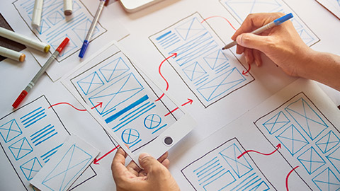 A person drawing wireframes