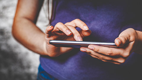 A person interacting with an app on a mobile phone