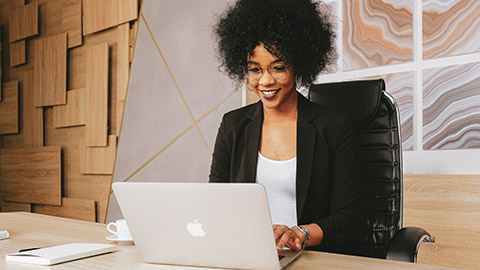 A designer working on a website on a laptop in a modern office space