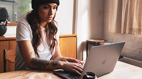 A photographer working on images on a laptop