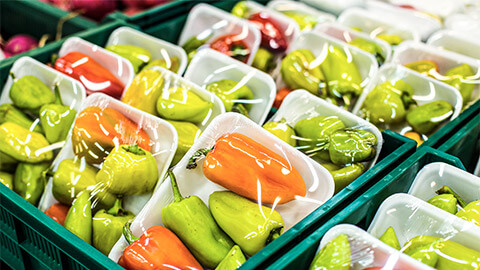 Fresh produce wrapped in a large amount of plastic