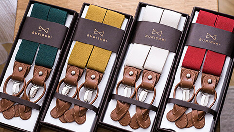 Four pairs of suspenders neatly packaged in their boxes