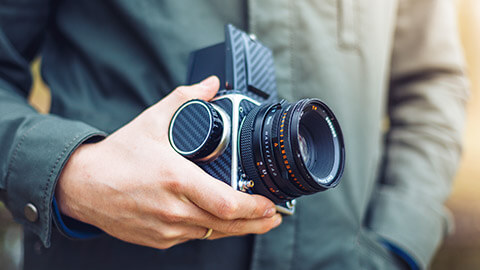 A person holding a medium format camera