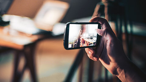 A close view of a person taking a picture with a mobile phone