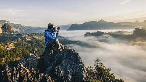 A photographer using natural light outdoors