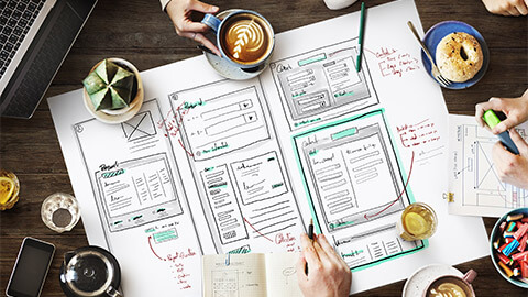 A group of UX designers reviewing a sites wireframe