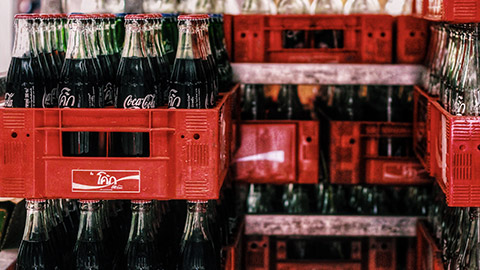 Crates of Coca Cola bottles in a warehouse