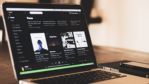 A close view of a laptop with Spotify open on the screen