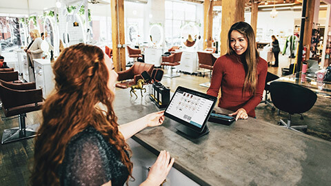 A store owner receiving informal feedback from a customer