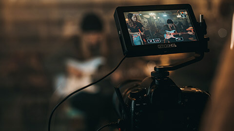 A close view of a monitor on a camera while shooting a video