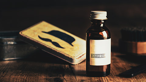 A bottle of beard oil sitting on a table