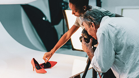 2 photographers using artificial light in a studio