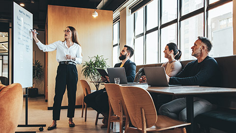 Employees of a startup discussing business issues in a modern office environment