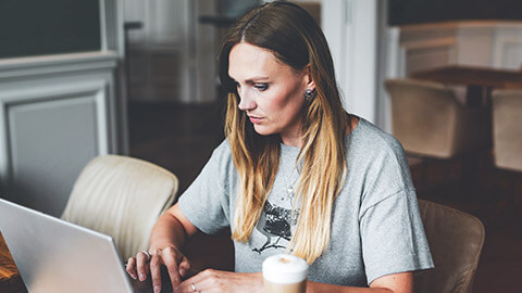 A young entrepreneur working on business projects on a laptop