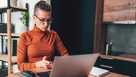 A designer deep in thought while working on a UX project