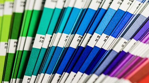 A close view of a spread of Pantone colour swatches