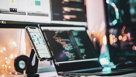 A designers desk setup with several devices visible