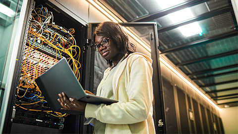 A developer running diagnostics on a large server