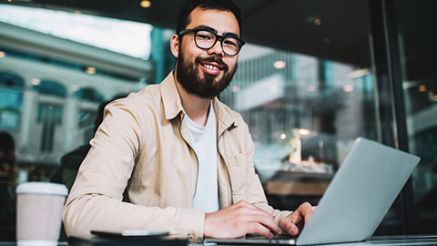 A programmer smiling at the camera after successfully completing a task