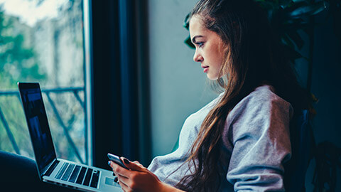 A young designer working on a site on a laptop