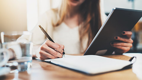 A close view of a person writing a contract