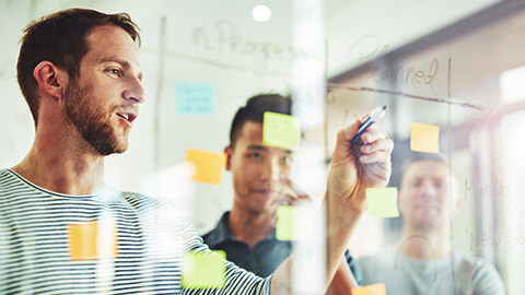 Developers working on a plan for a project using sticky notes