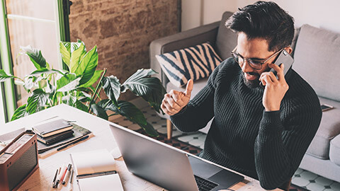 An IT worker talking to a colleague on a phone