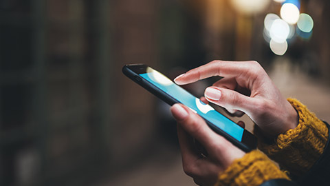 A close view of a person holding a mobile phone