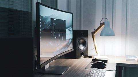 A computer screen sitting on a desk